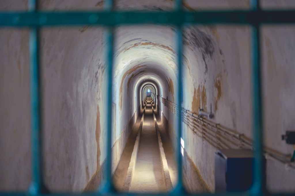 a view down a long corridor through a gate